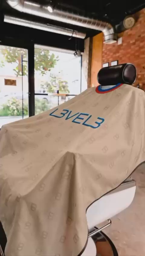 Cargar video: L3VEL3 CAPE WITH RUBBER NECK (BEIGE W/RED TRIM)